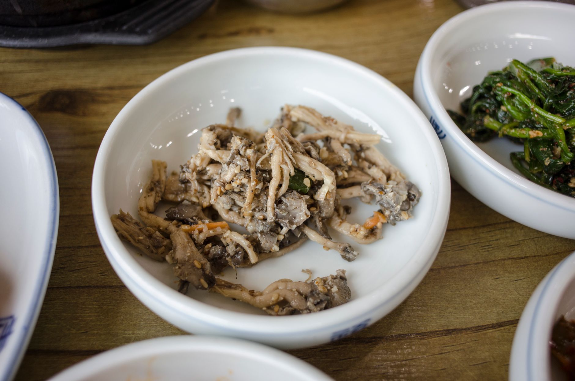A delicious assortment of traditional Korean banchan side dishes served in ceramic bowls.