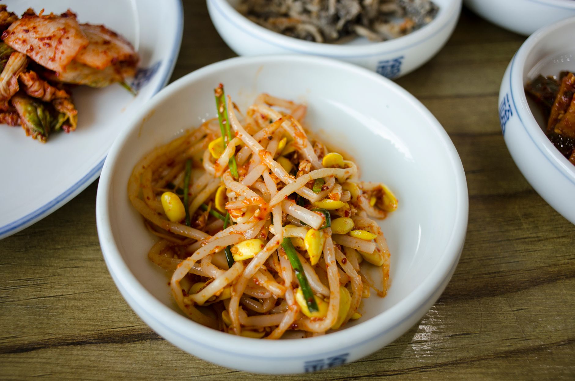 A close-up of a Korean mung bean sprout side dish served in a bowl, featuring vibrant colors and textures.