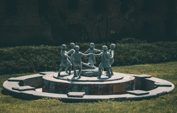 Sculptures Of Children In A Park