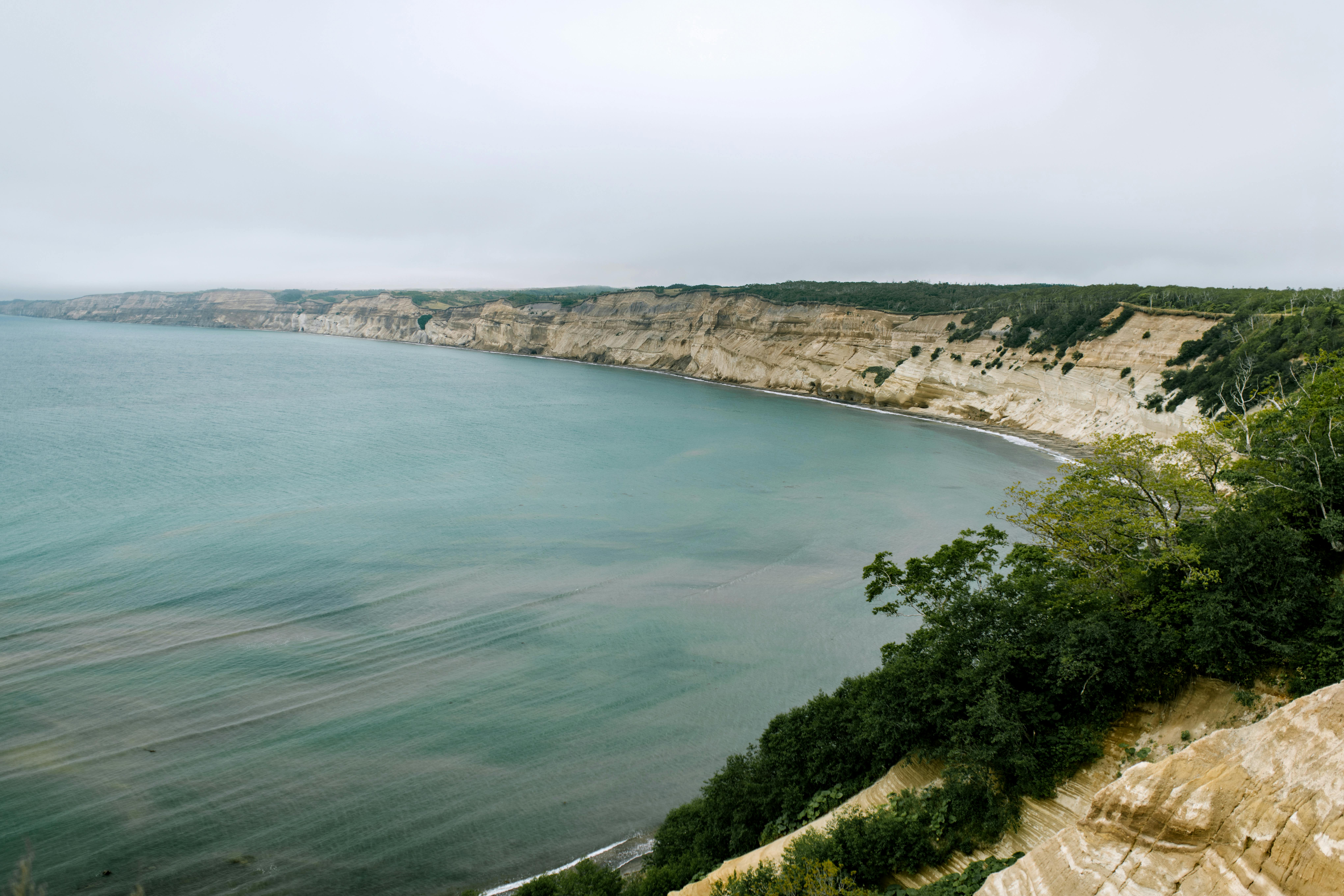Breathtaking view of cliffs meeting the sea, capturing Sakhalin's dramatic coastline.