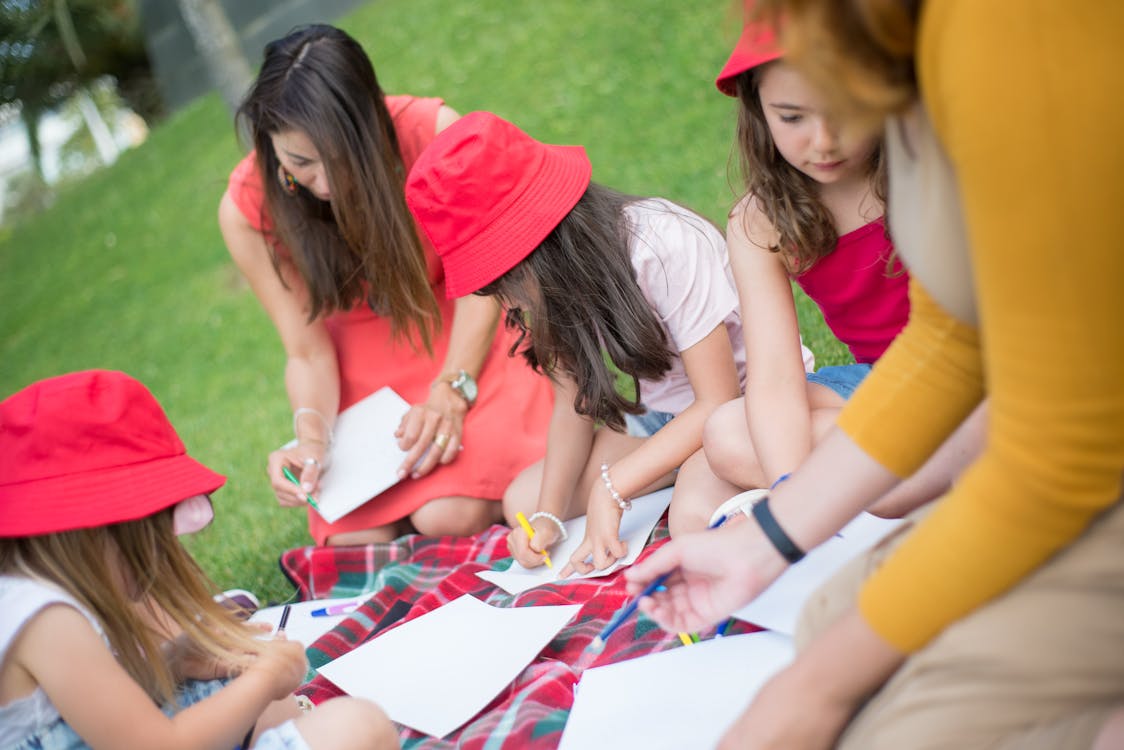 People Sitting on Grass Field