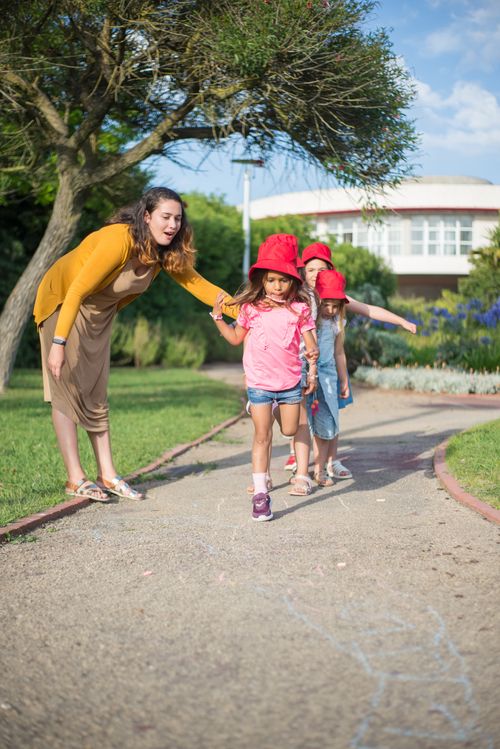 Free A woman walks with two children on a park path in Portugal. Stock Photo