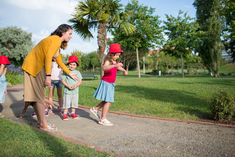 A Woman With Children Playing Games Together 