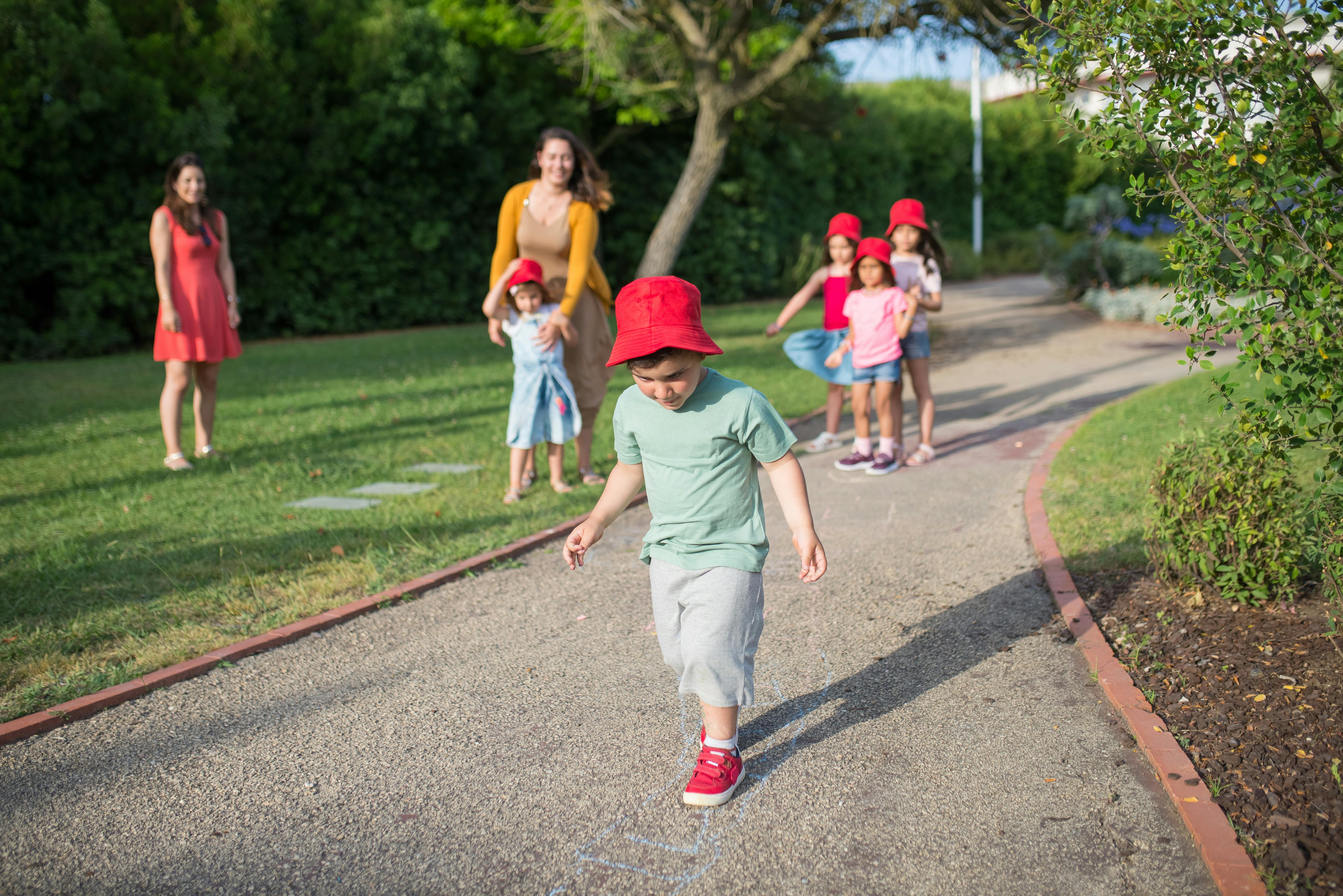 a boy wearing a red hat while playing