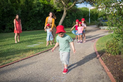 Free Group of children playing games outdoors in a sunny park in Portugal. Stock Photo
