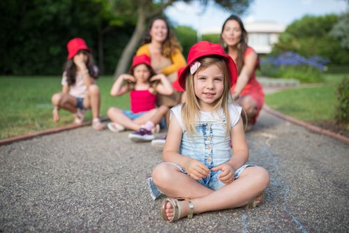 Free A group of smiling children wearing red hats enjoy a playful day outdoors in Portugal. Stock Photo