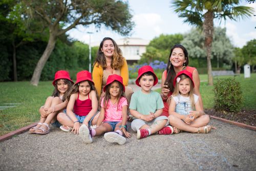 Free Happy group of kids and adults outdoors in Portugal, smiling and having fun in a park setting. Stock Photo