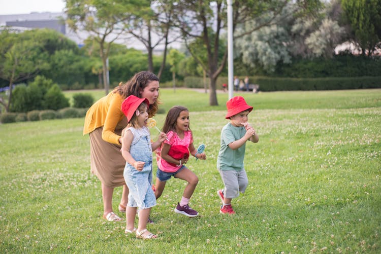 Mother And Her Children On Grass