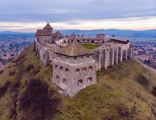 Free Stunning aerial shot of Sümeg Castle in Hungary with a beautiful sunset in the backdrop. Stock Photo