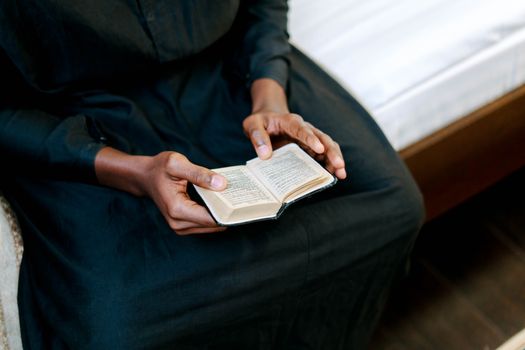 Person in Blue Dress Shirt Holding Book