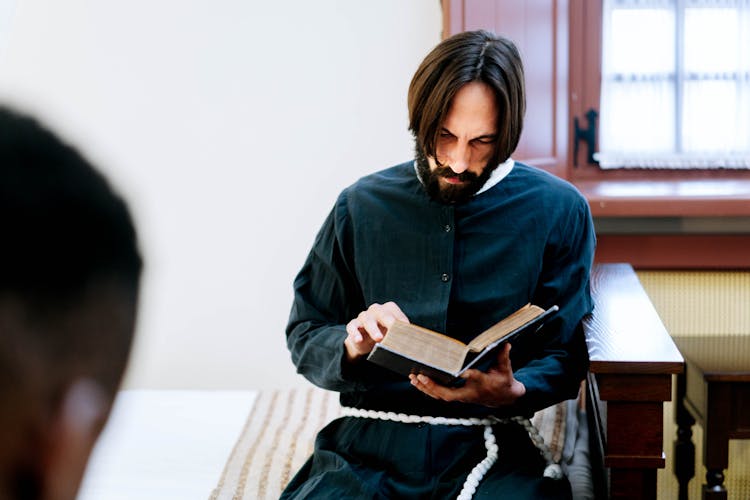 A Man Reading A Bible