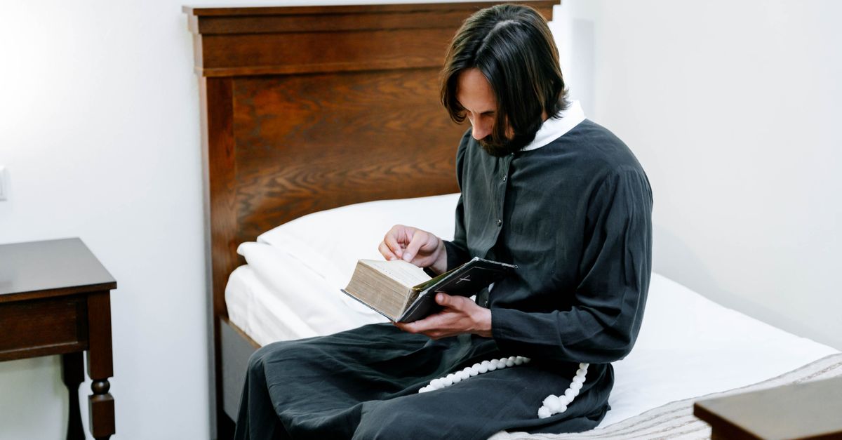 Gen Z person sitting in a quiet, sunlit room reading a leather bible with a cup of water, minimalistic aesthetic