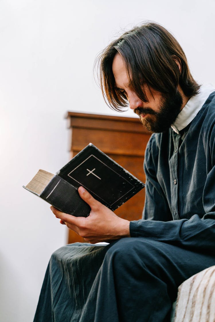 A Bearded Man Reading A Bible