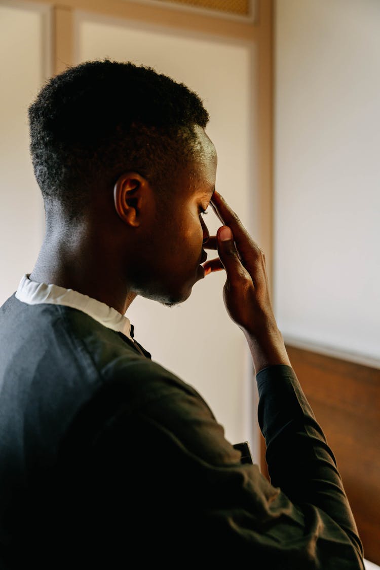 Close-up Photo Of Man Doing The Sign Of The Cross 