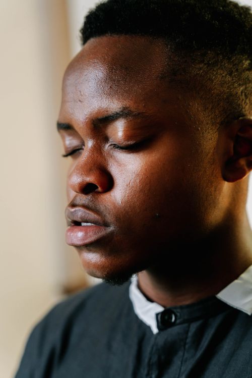 Free A contemplative close-up of a young man with closed eyes, conveying calmness. Stock Photo