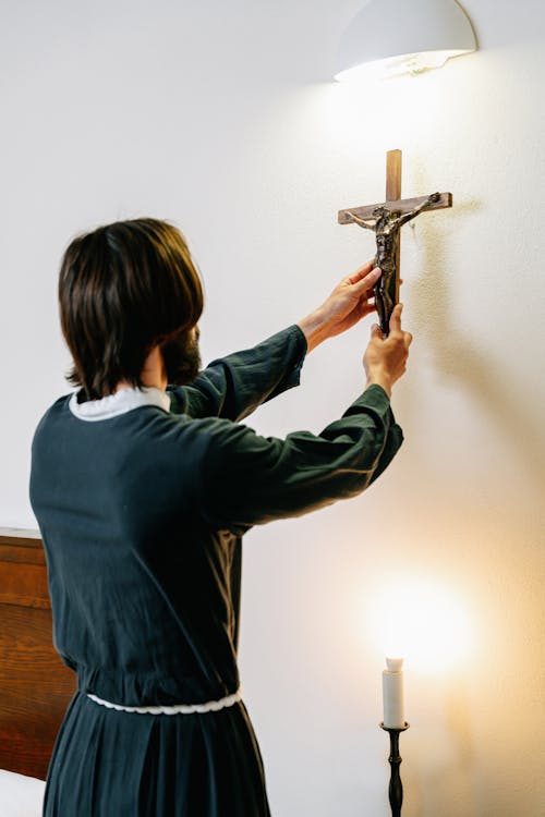 Free Man Putting a Cross on a Wall Stock Photo
