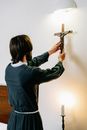 Man Putting a Cross on a Wall