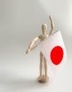Wooden Figurine with a Japanese Flag