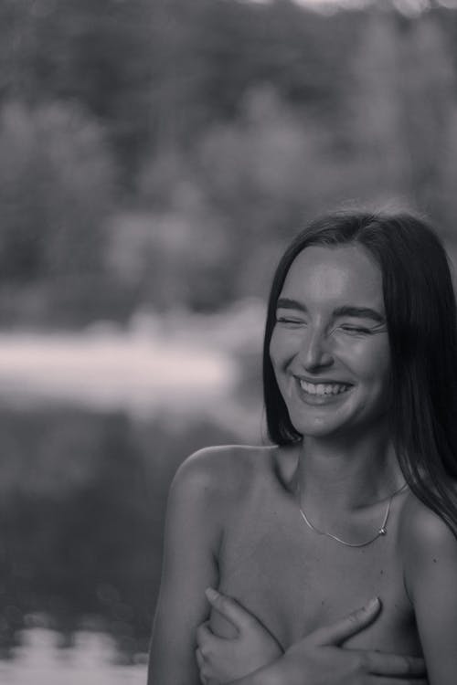 Free A Grayscale Photo of a Topless Woman Smiling Stock Photo