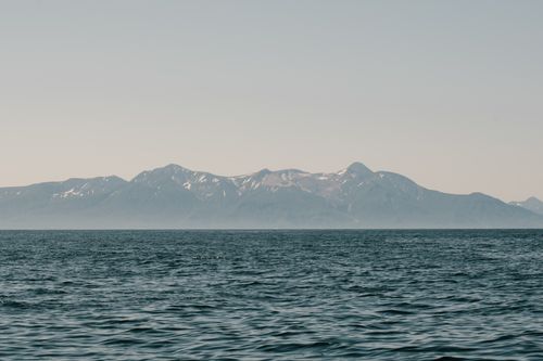 Free Tranquil scene capturing mountains across the sea in Sakhalin, Russia, under a clear sky. Stock Photo
