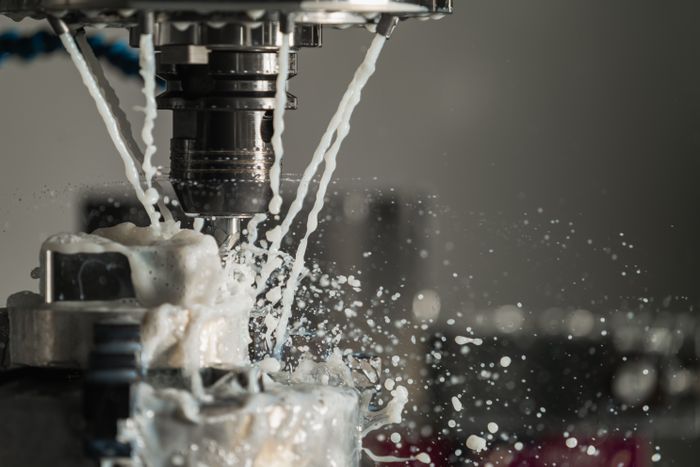 CNC machine cutting metal with coolant