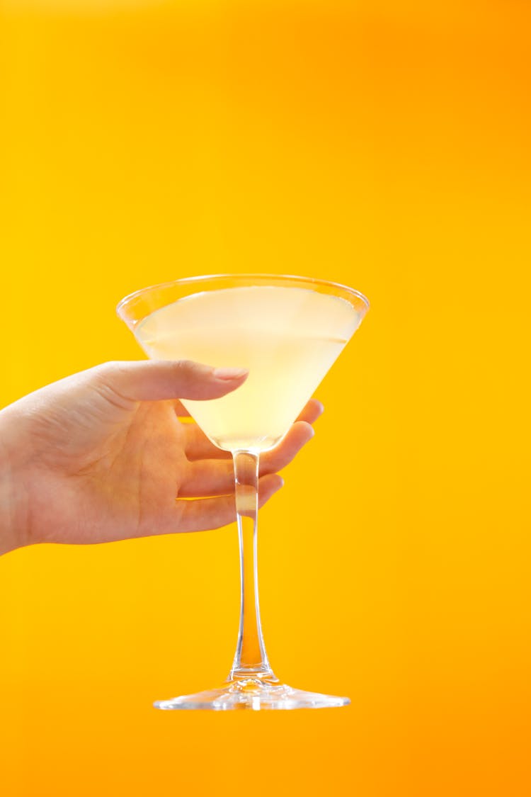 A Person Holding A Clear Martini Glass