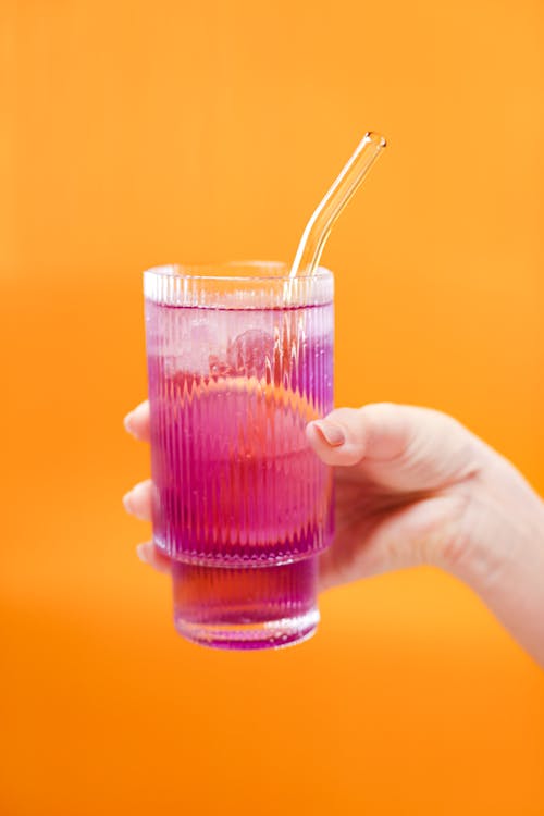 Free Person Holding Clear Drinking Glass With Purple Liquid Stock Photo