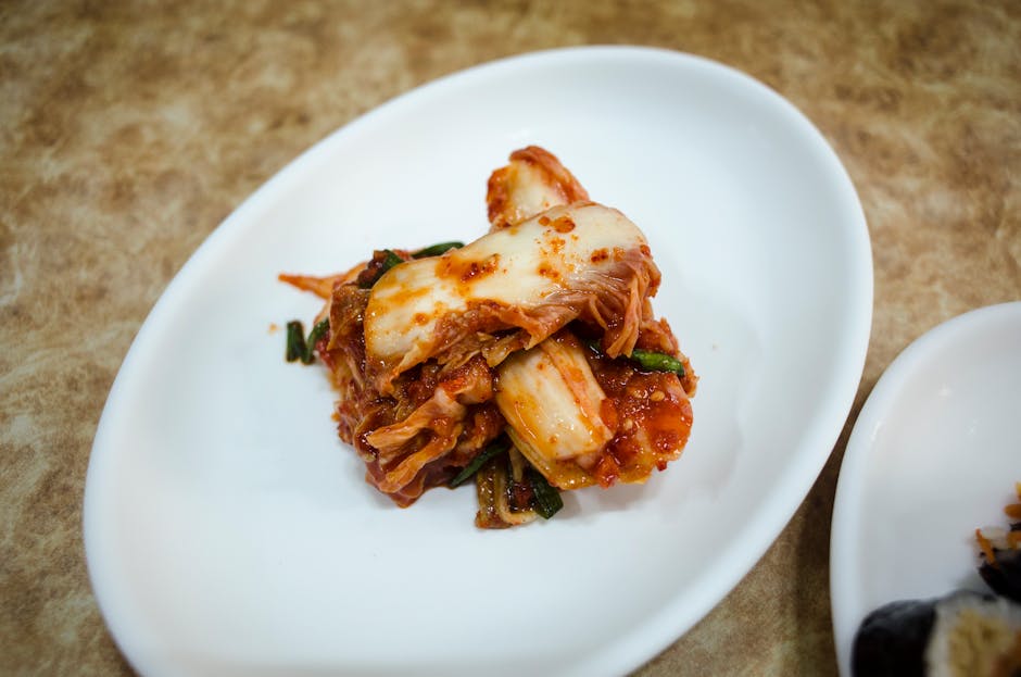 A plate of traditional fermented Korean kimchi presented elegantly on a white dish.