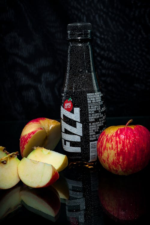 A Bottle of Appy Fizz Cocktail Drink Beside Apples