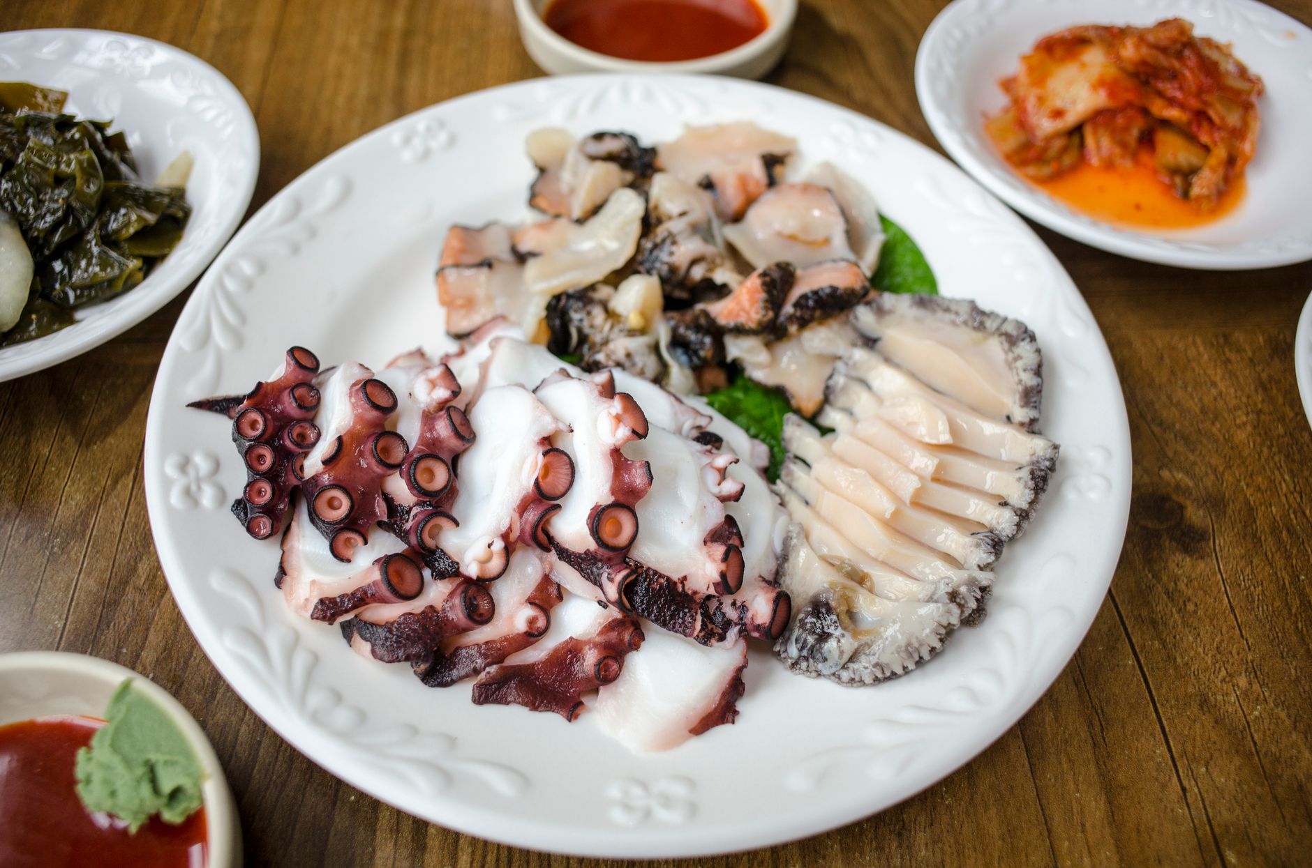A vibrant table setting featuring a fresh seafood platter and side dishes, perfect for a culinary adventure.