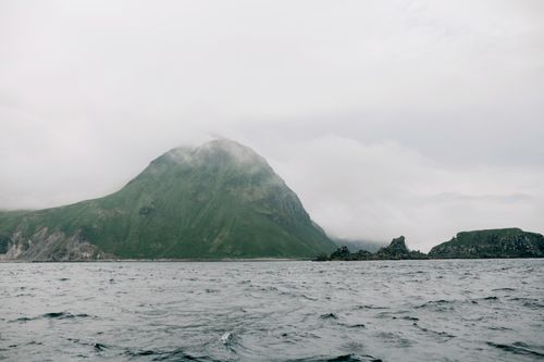 Free A misty mountain view from Sakhalin Island, Russia, captures serene ocean and nature. Stock Photo