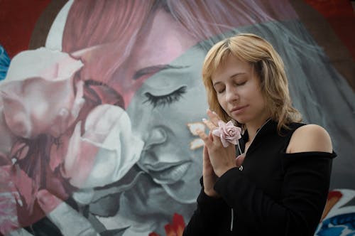 Woman in Black Long Sleeves Wearing a Flower Ring 