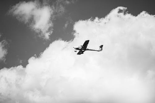 Grayscale Photo of a Flying Plane