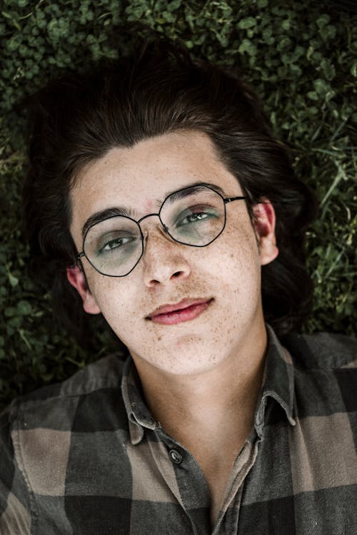 Man Wearing Eyeglasses Lying on Grass