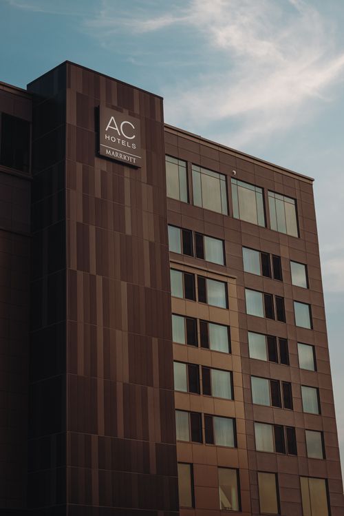 Free Low angle shot of AC Hotels by Marriott facade against a clear sky. Stock Photo
