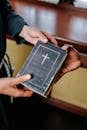 Person Holding Black and White Book