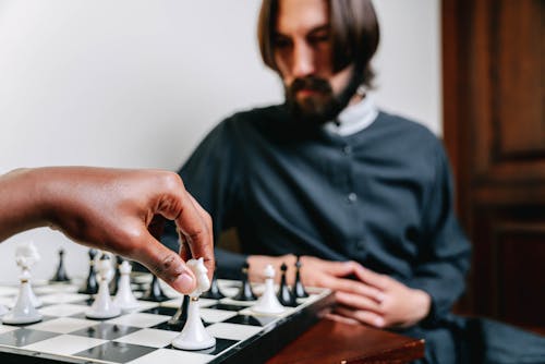 A Man and a Person Playing Chess