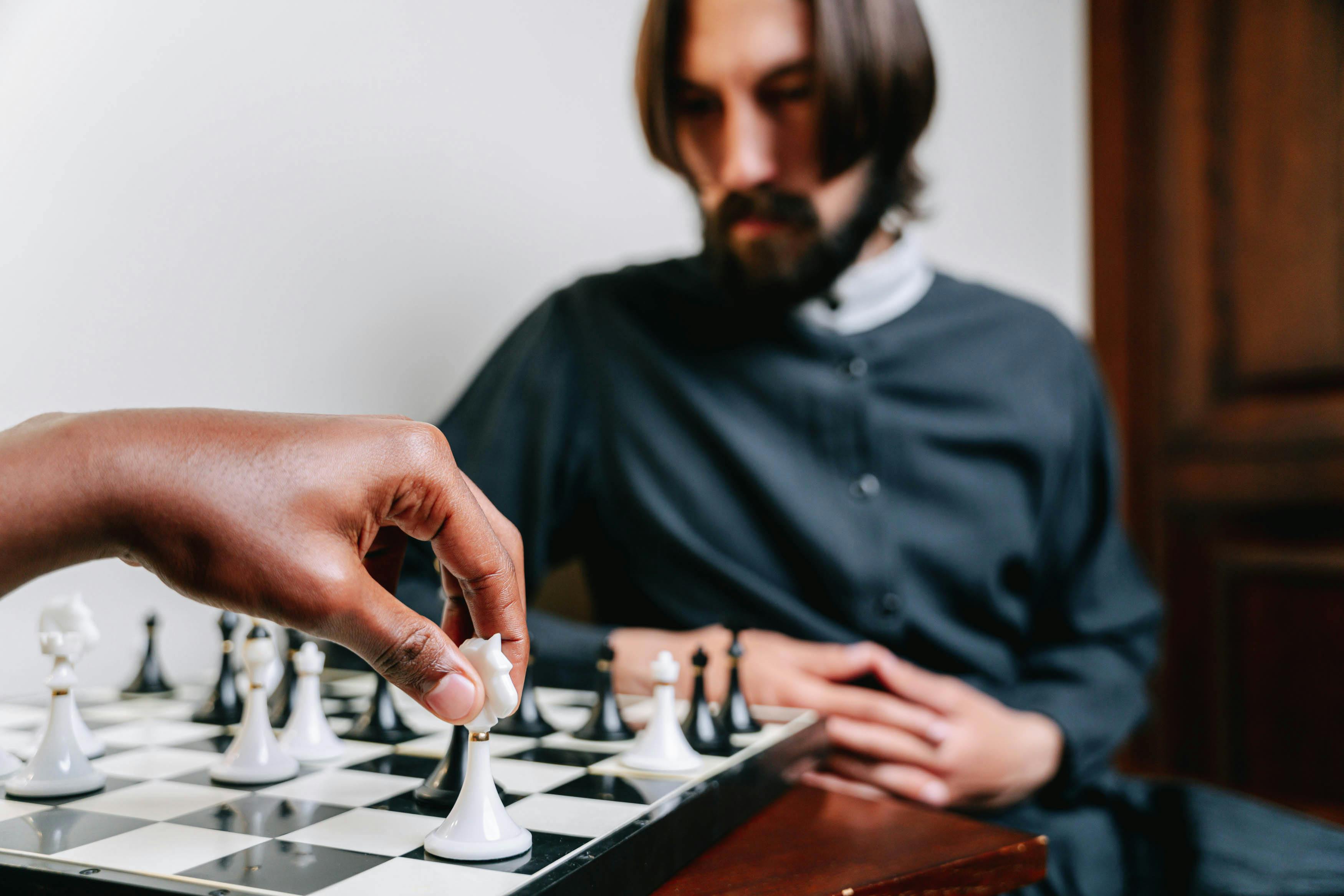 Caucasian man playing chess computer hi-res stock photography and