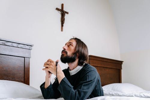 Man in Black Long Sleeve Praying