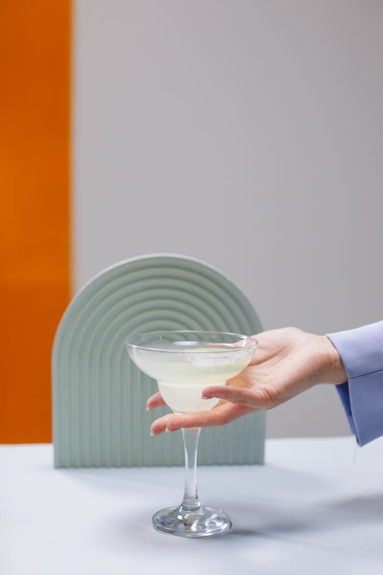 A Person Holding A Margarita Glass With An Alcoholic Drink