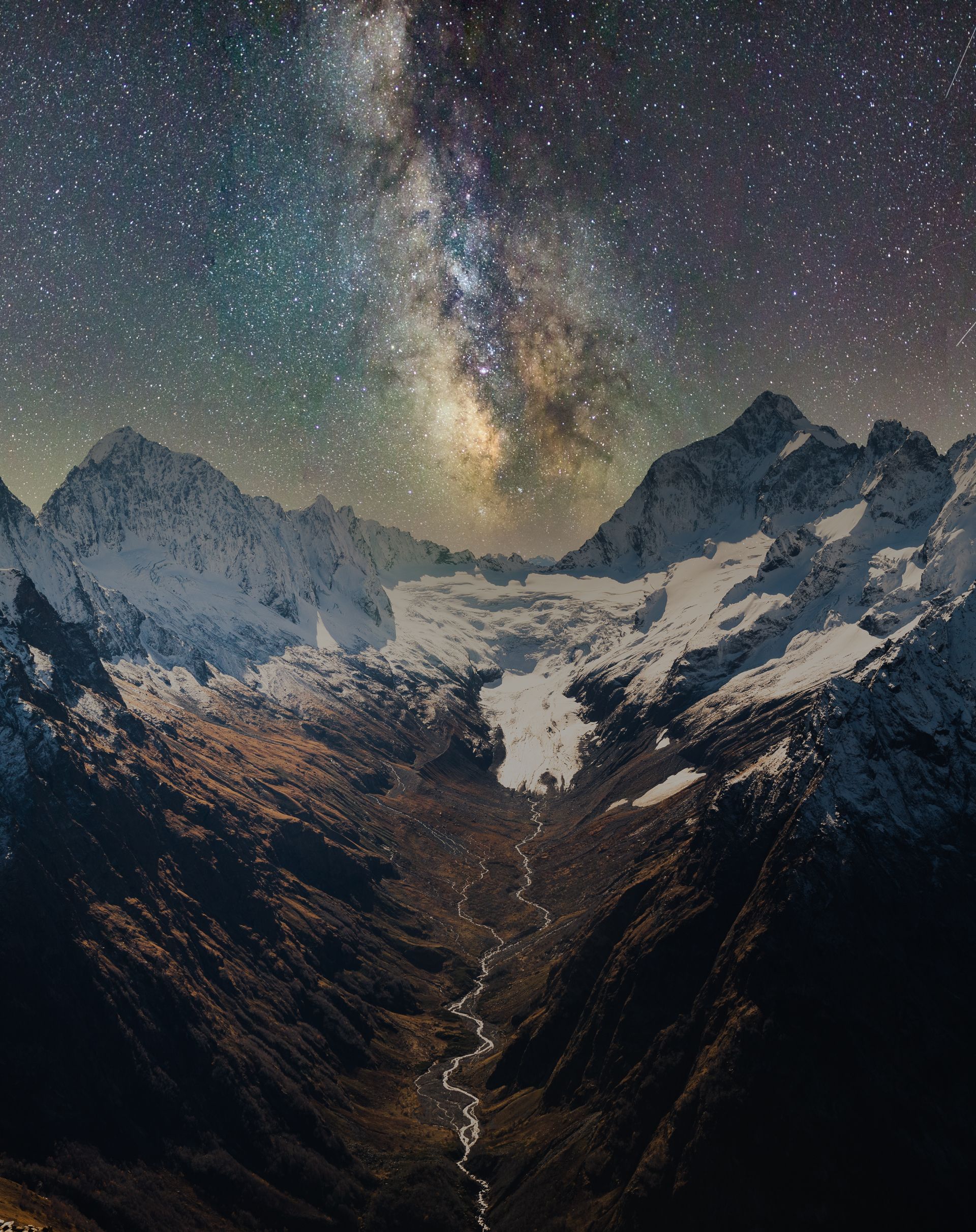 Breathtaking view of the Milky Way over snow-covered mountains in Dombay, Russia.