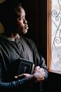 Man in Black Jacket Holding Book