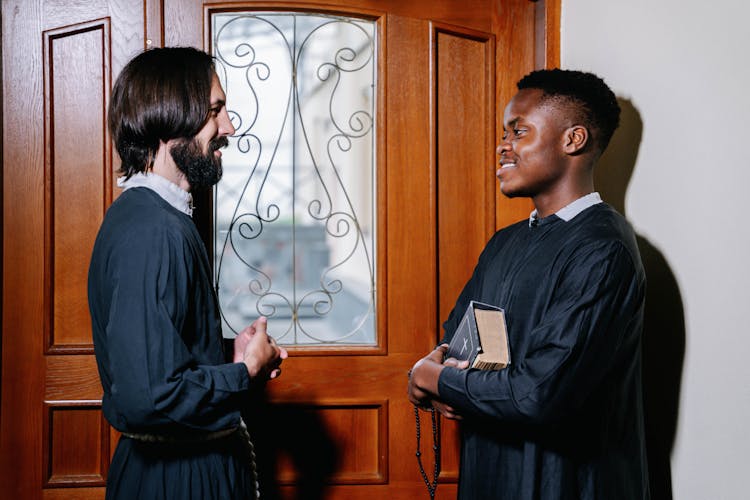 Priests Looking At Each Other