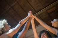 3 Women in Blue and White Tank Top Raising Their Hands
