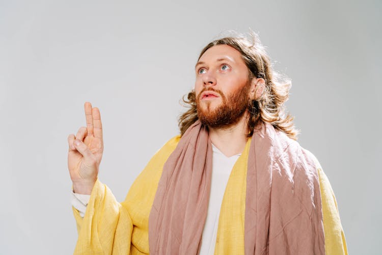 A Jesus Look Alike Man In Yellow Robe 