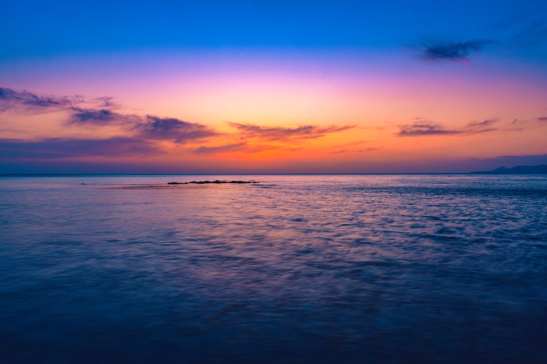 Blue Sea Under Blue and Orange Sky during Sunset · Free Stock Photo