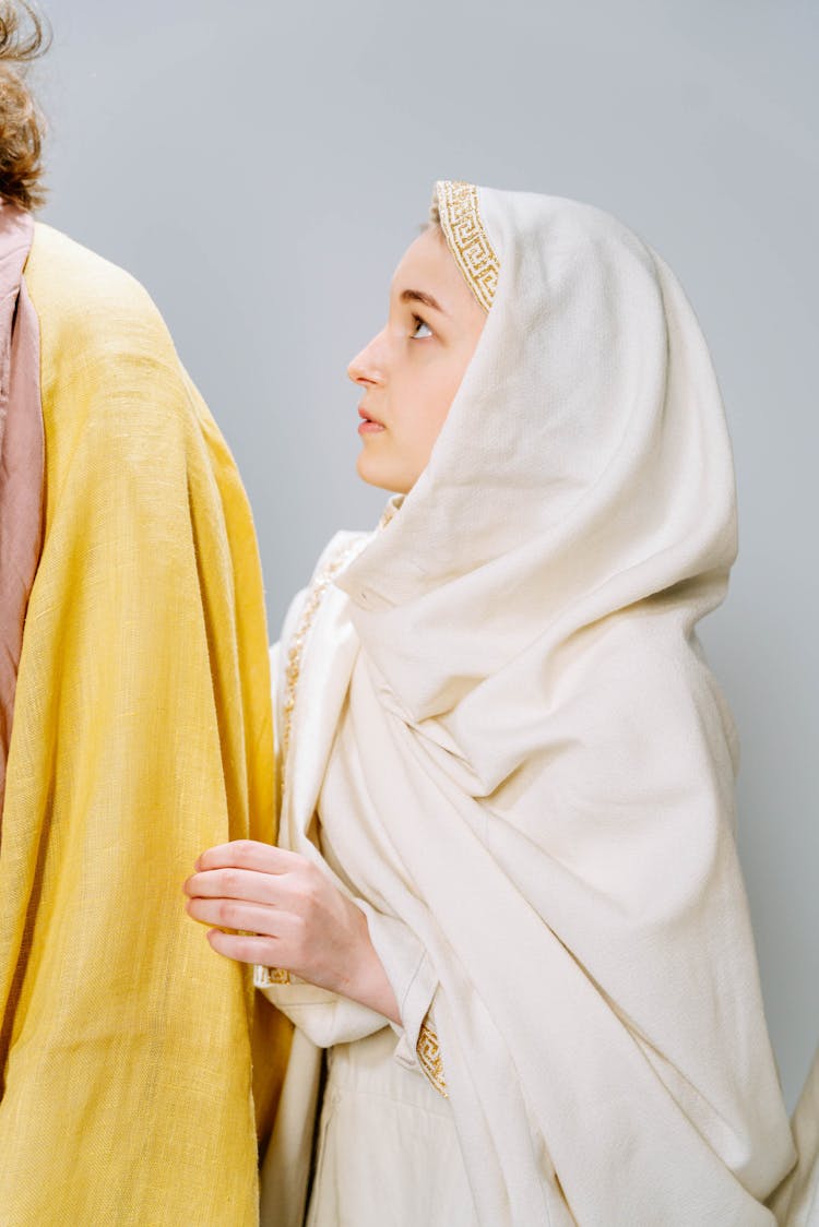 Woman In A White Headscarf And Cloak