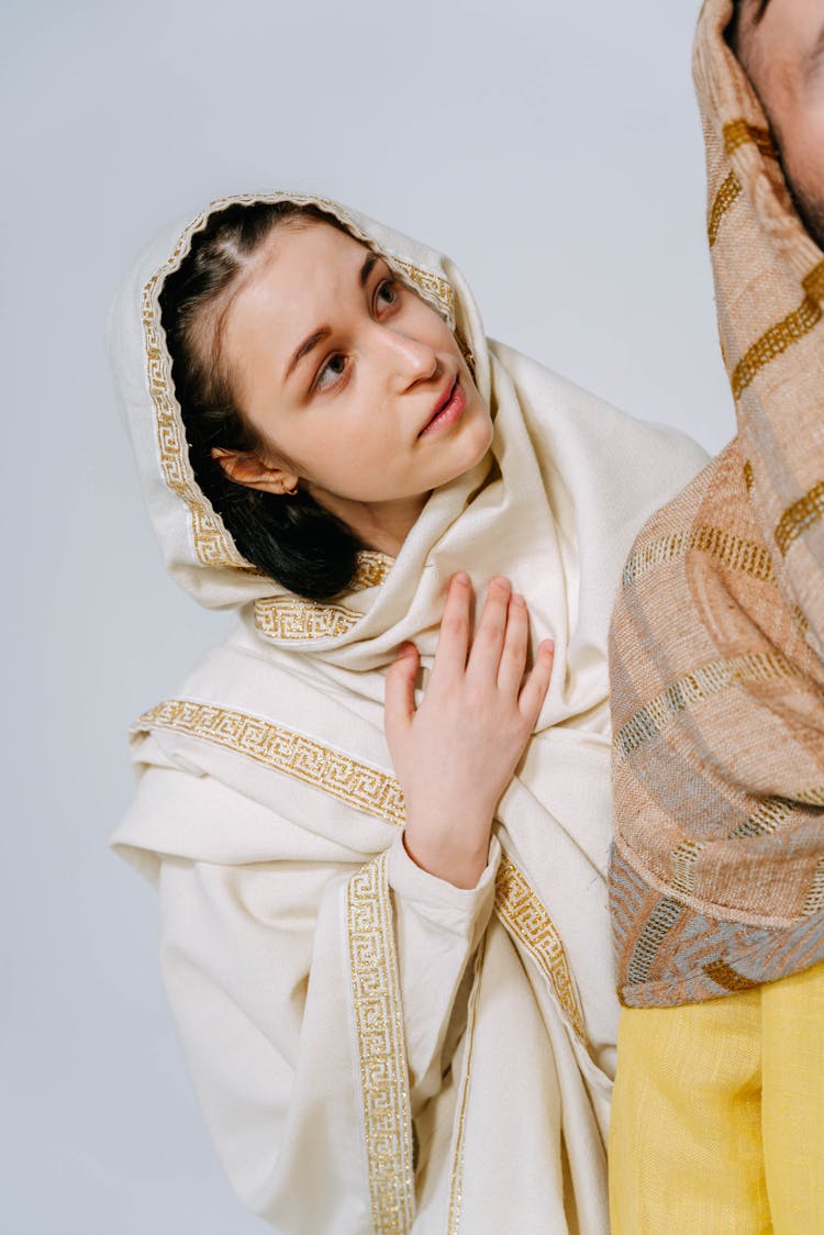 A Beautiful Woman Wearing A White Cloak And Headscarf