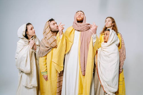 Group of People Wearing Headscarves and Cloaks