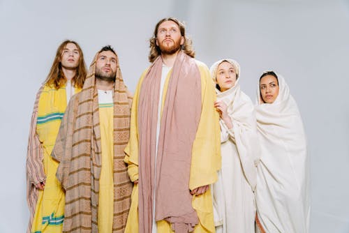 People Wearing Yellow and White Robes
